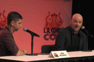 Ryan McCaffrey sat next to Dan Houser at a table.