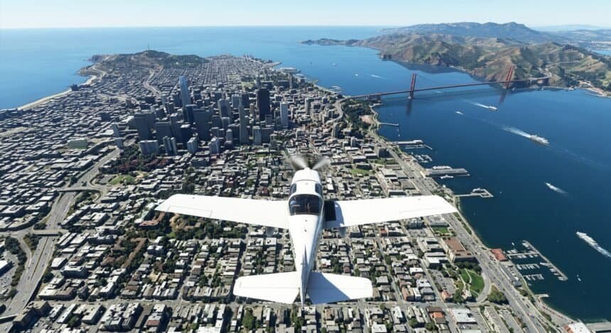 A small white plane flies over downtown San Francisco and the Golden Gate Bridge in a flight simulator