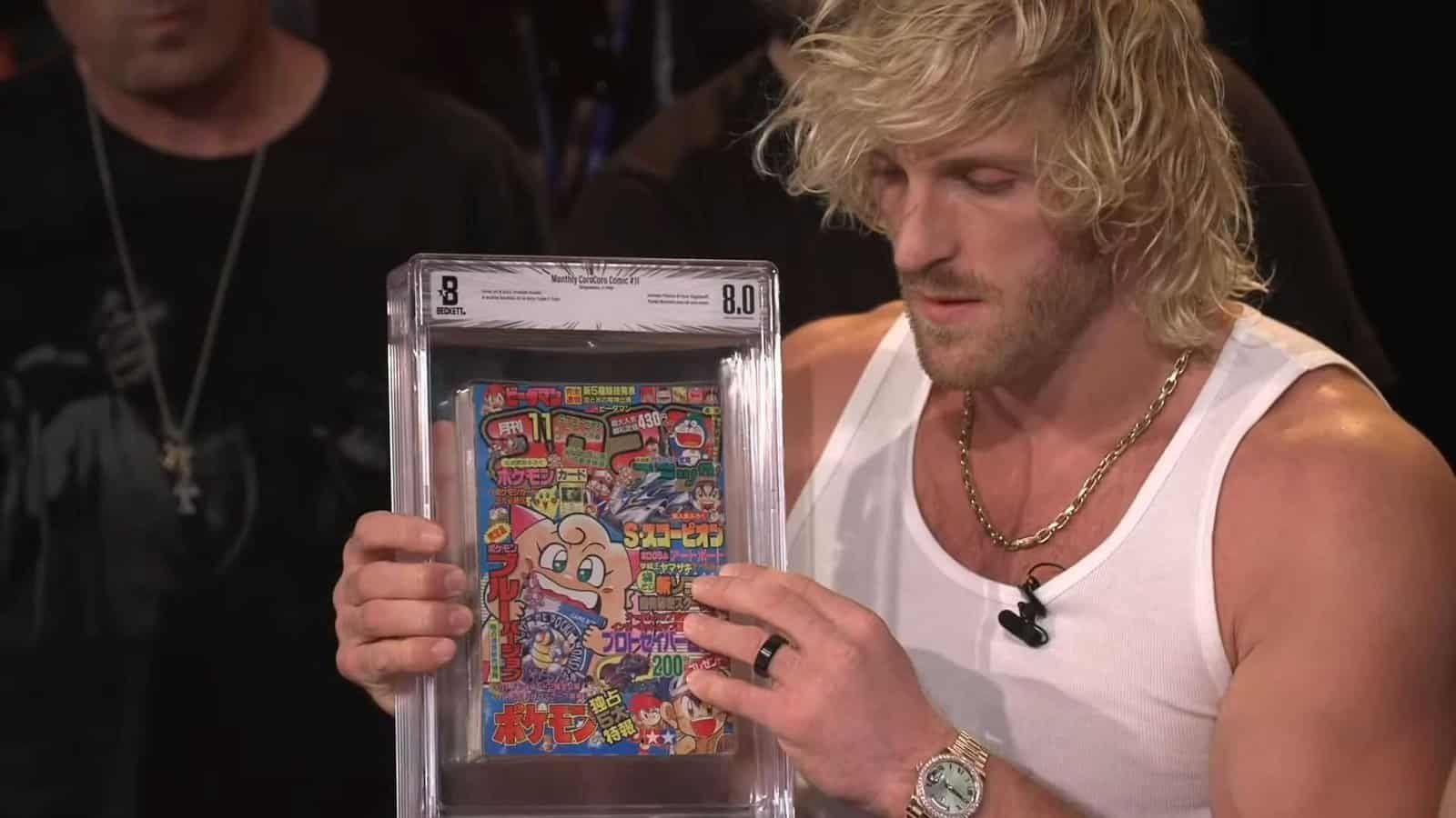 Logan Paul holds a perfectly graded CoroCoro magazine during a Pokemon livestream.