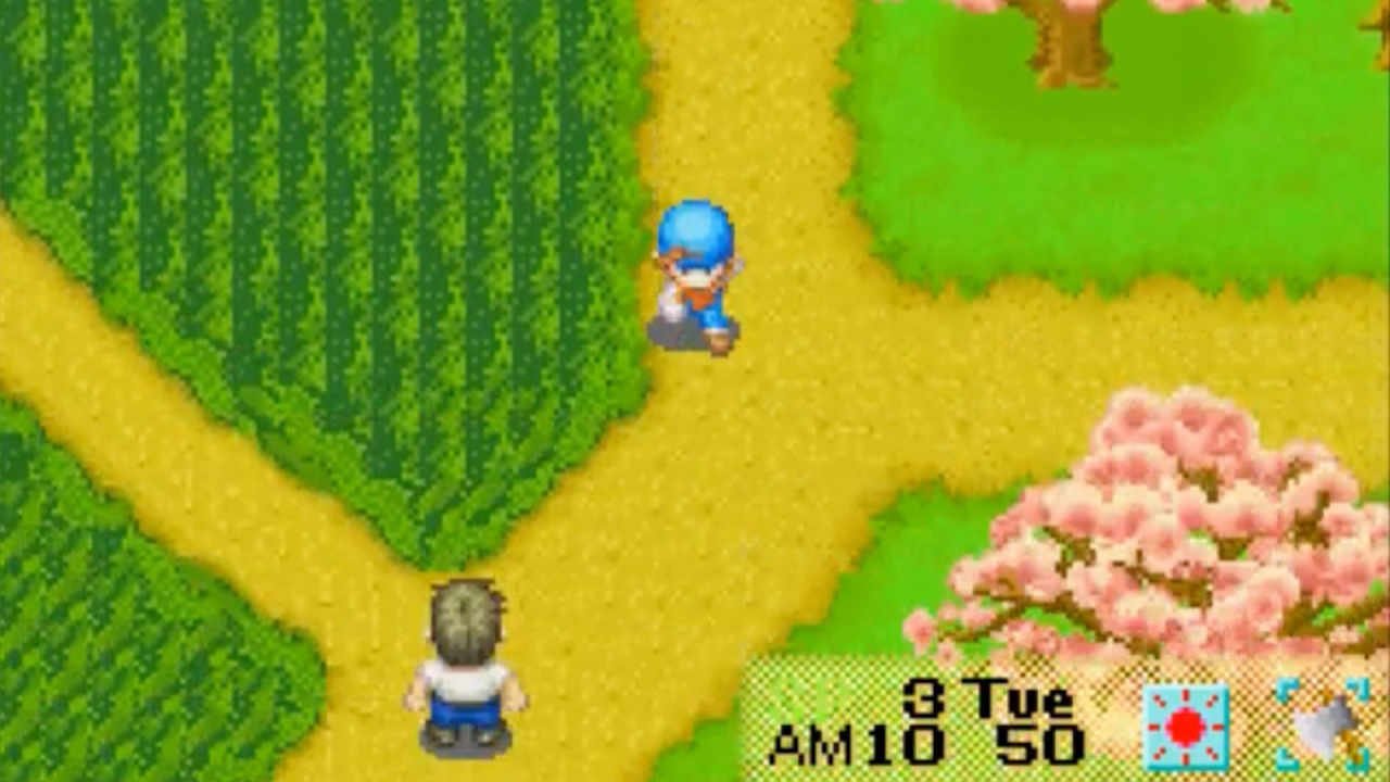 A farmer from Harvest Moon: Friends of Mineral Town runs through the fields.