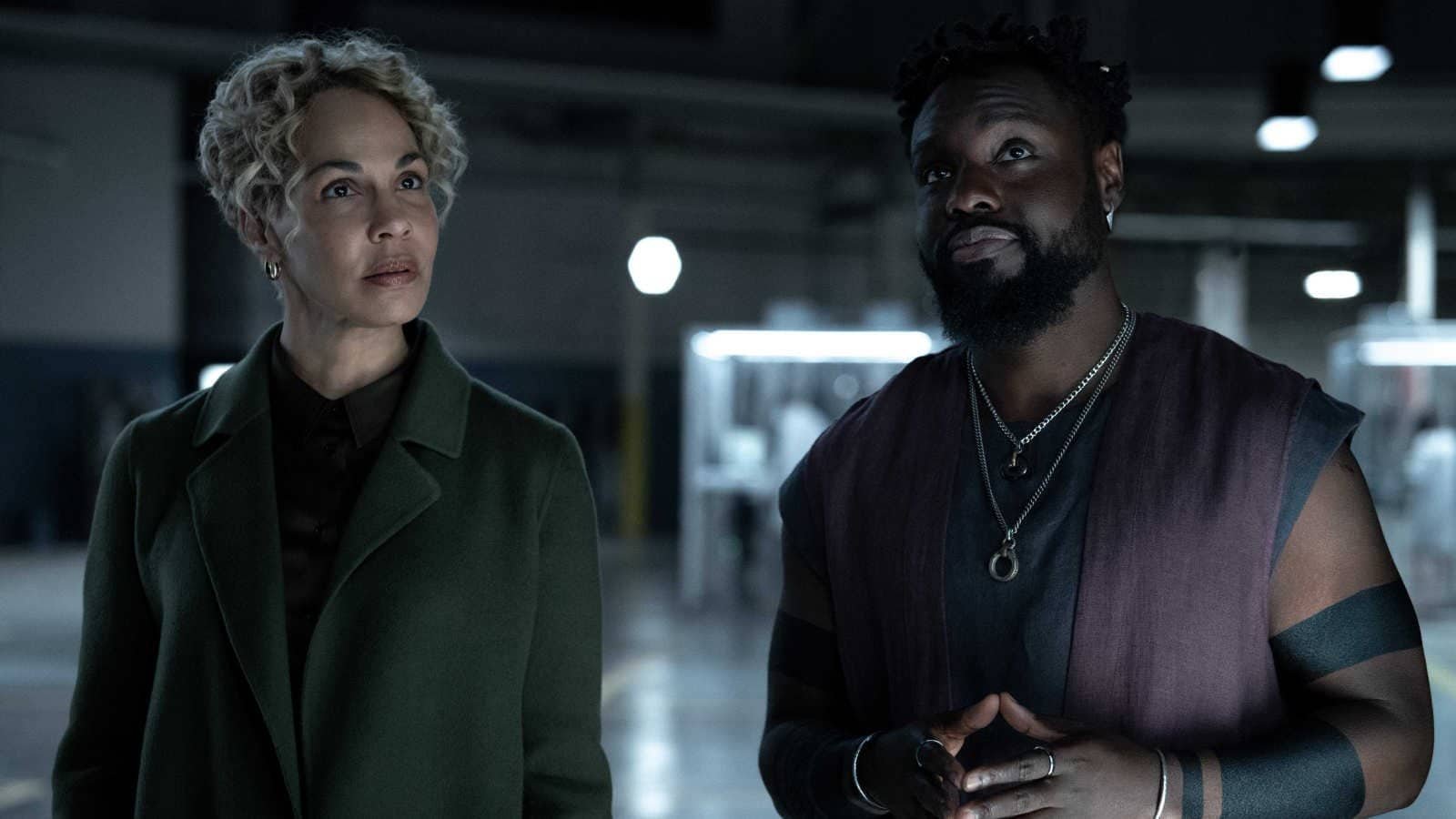 Blair Caplan (Amanda Brugel) stands next to a version of Leighton Vance (Dayo Okeniyi) in Velocity Labs in Dark Matter season 2.