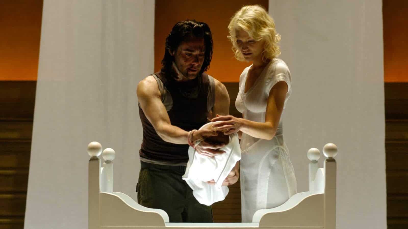Gaius and Six holding a baby in Battlestar Galactica.