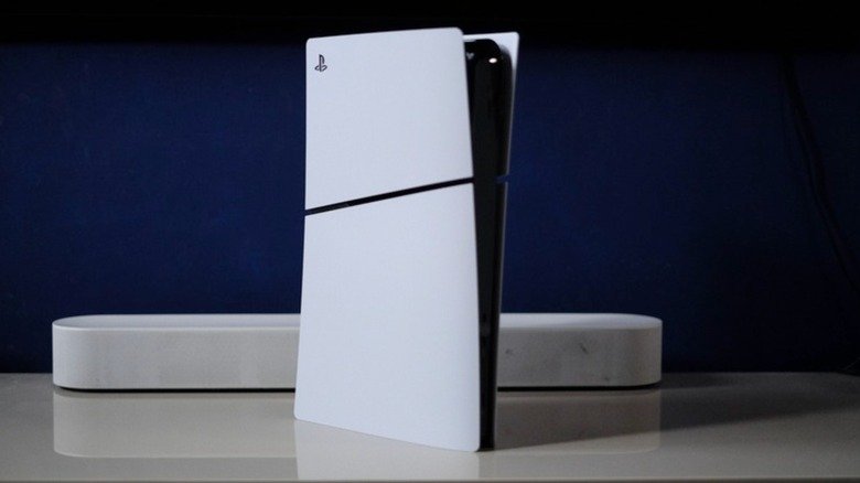 A PS5 with a soundbar against a dark blue background