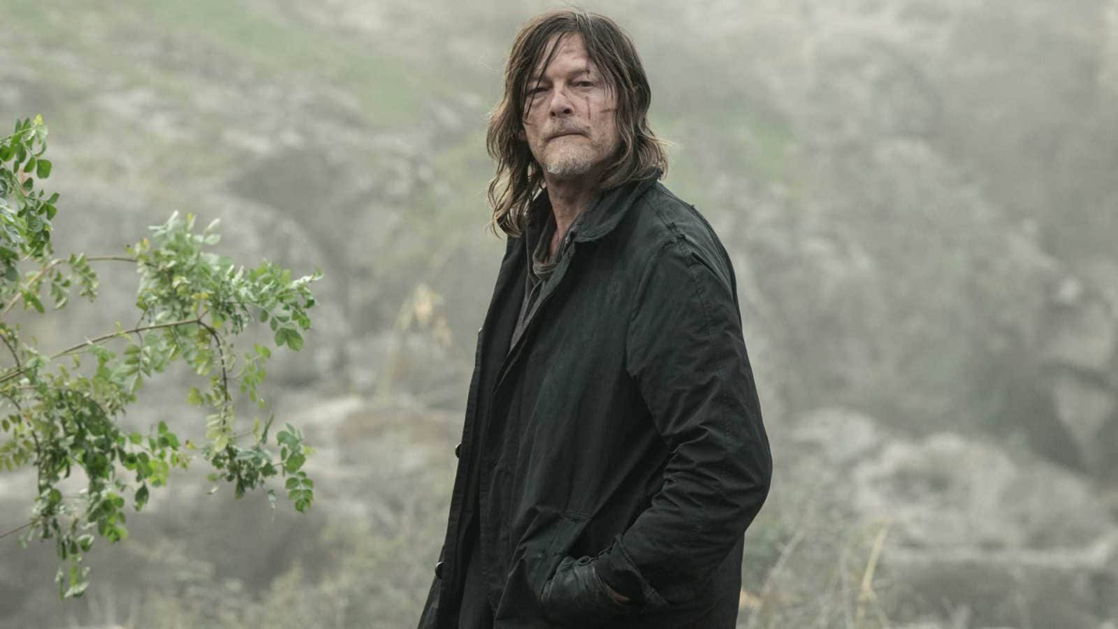Norman Reedus as Daryl Dixon with his hands in his jacket pocket looking into the distance in The Walking Dead: Daryl Dixon season 3