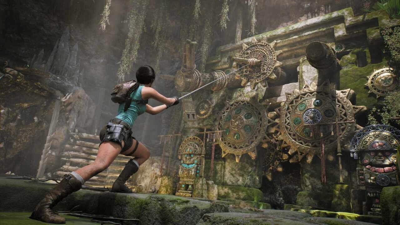 Lara Croft yanks a gear with a hook in Tomb Raider: Legacy of Atlantis.