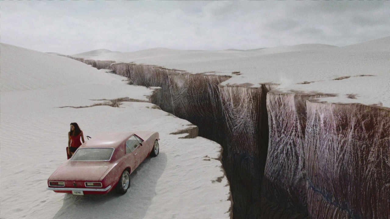 Grace (Christina Ochoa) standing by her car and the ravine in Blood Drive.