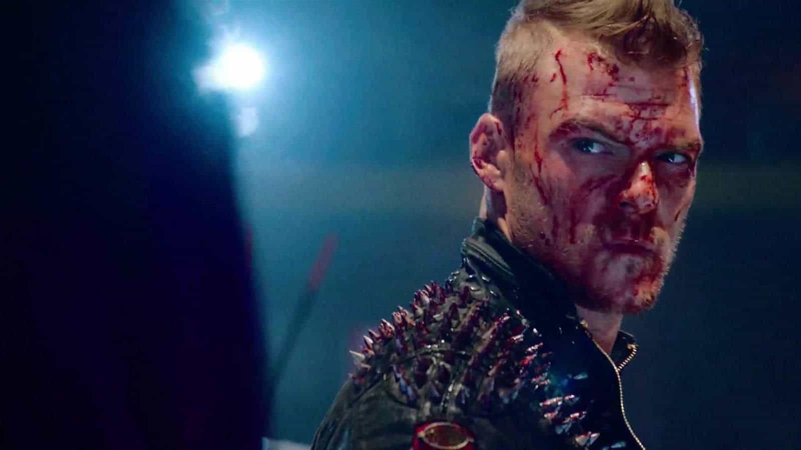 Barbie (Alan Ritchson) covered in blood in Blood Drive.