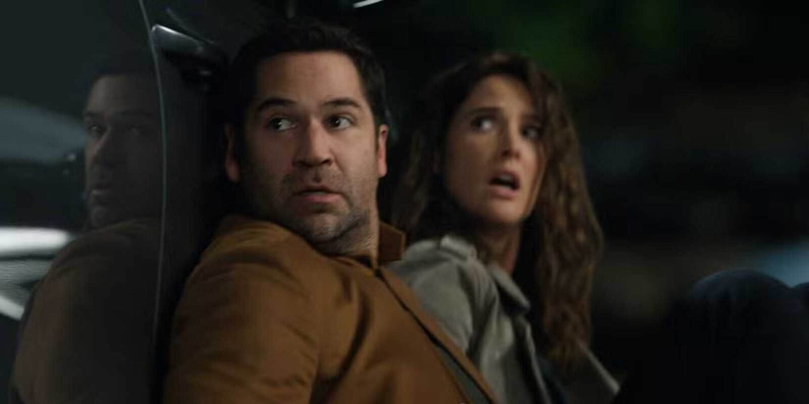 Mickey Haller and Emi Finch hide behind a car at the end of The Lincoln Lawyer season 4